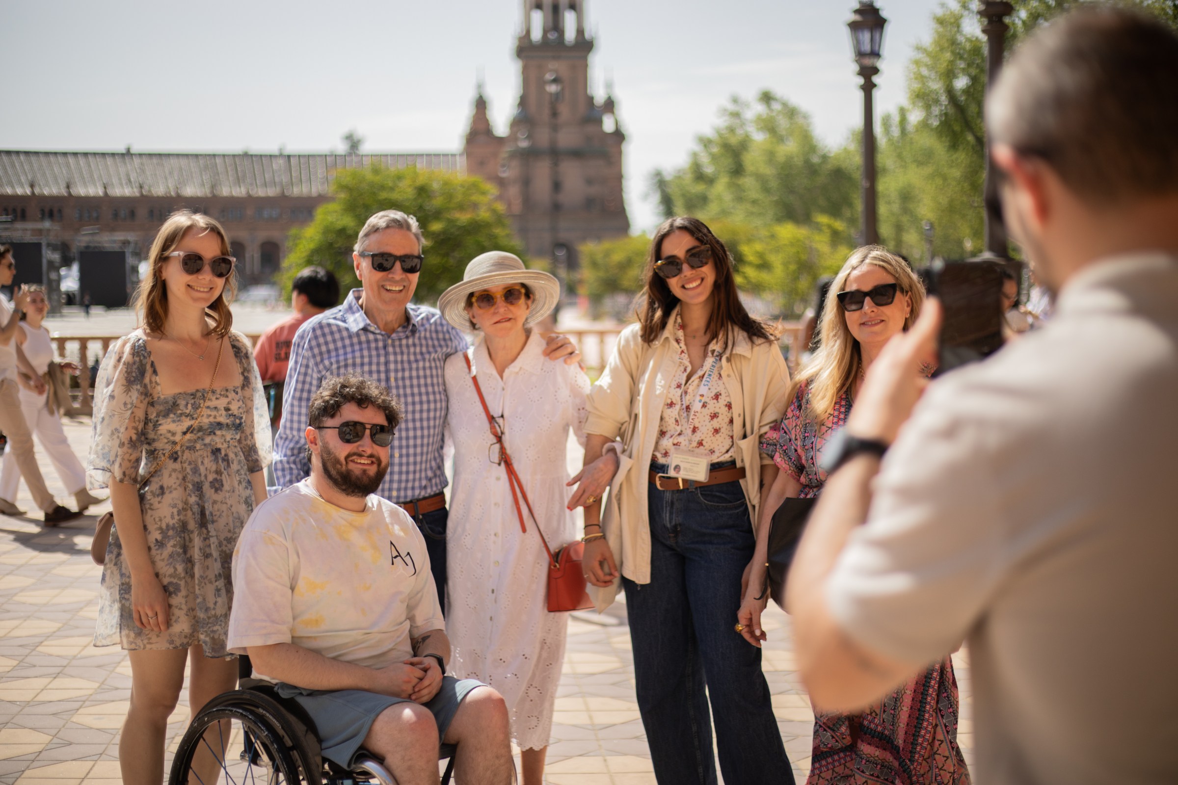 Group of tourists taking a picture in Plaza de España, Seville, Spain