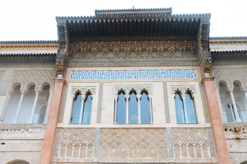 Ornate building facade with arches, intricate designs, and brick accents.