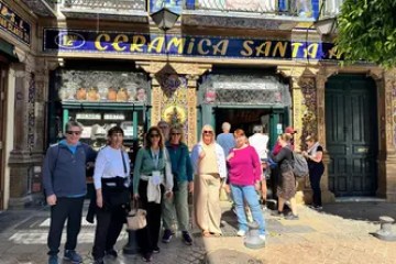 Group of people posing in front of Ceramica Santa Ana store.