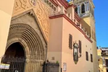 Gothic-style church facade with arched doorway and bell tower.