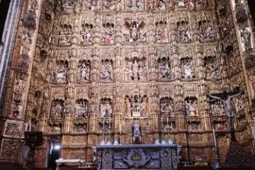 Ornate church altar with intricate carvings and religious figures.